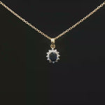 Load and play video in Gallery viewer, Yellow Gold Necklace with Deep Blue Oval Sapphire Charm